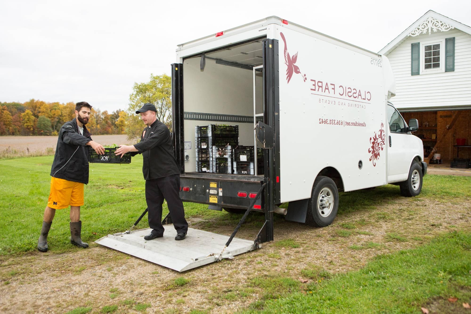 farm manager loads campus dining truck with produce from the SAP